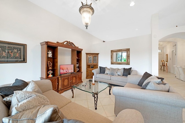 living room featuring high vaulted ceiling and light tile patterned floors