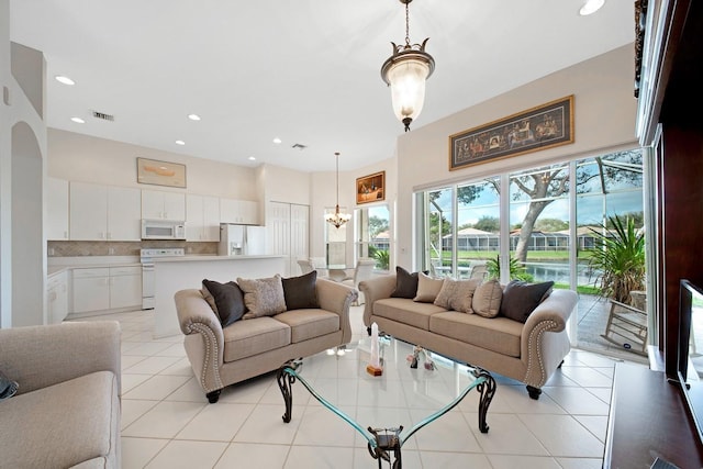 living area with light tile patterned floors, a chandelier, visible vents, and recessed lighting