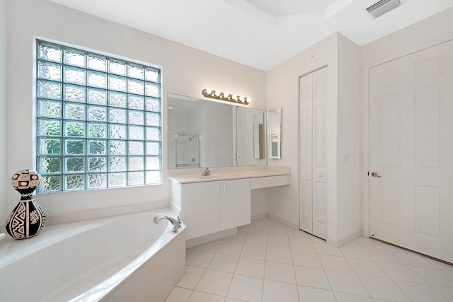 bathroom with vanity, a bathtub, and tile patterned flooring