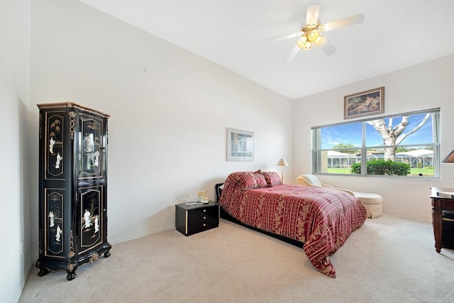 carpeted bedroom with vaulted ceiling, a ceiling fan, and baseboards