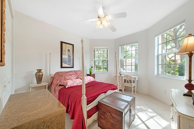 bedroom featuring a ceiling fan and multiple windows