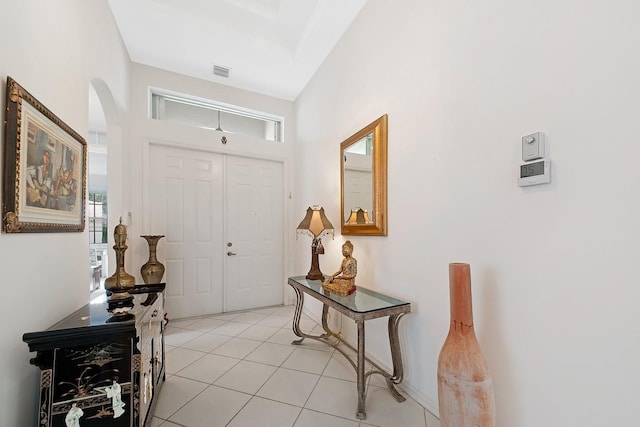 entryway featuring visible vents, arched walkways, and light tile patterned flooring