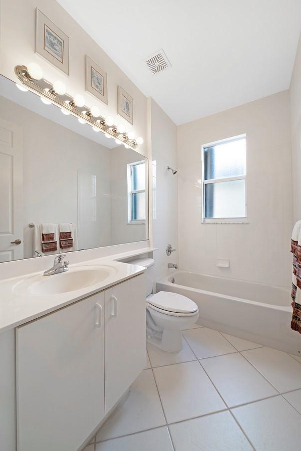 bathroom featuring shower / bath combination, plenty of natural light, visible vents, and tile patterned floors