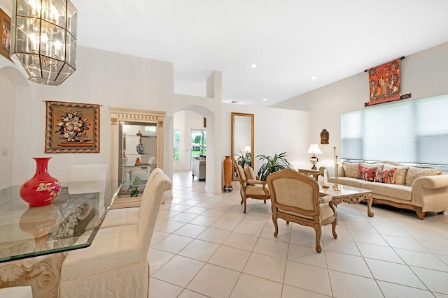 tiled living room featuring an inviting chandelier and a healthy amount of sunlight