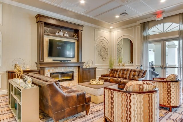 interior space with ornamental molding, a fireplace, light hardwood / wood-style floors, french doors, and coffered ceiling