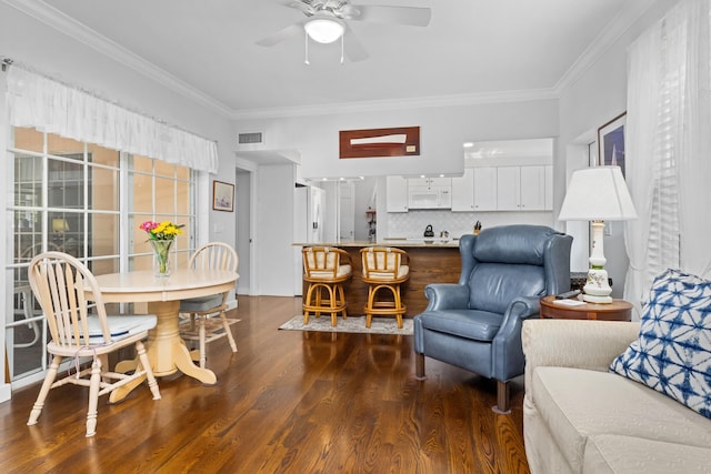 living room with dark hardwood / wood-style floors, ceiling fan, and ornamental molding