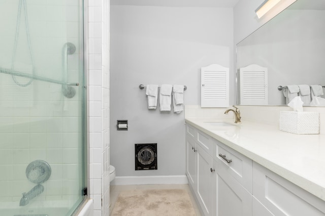 bathroom with tile patterned floors, a shower with door, and vanity