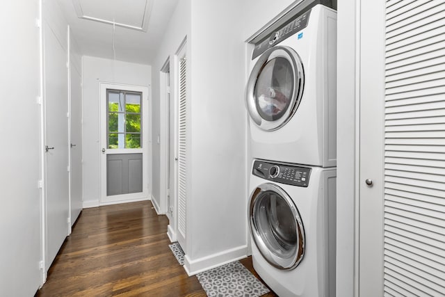 clothes washing area with dark hardwood / wood-style flooring and stacked washing maching and dryer