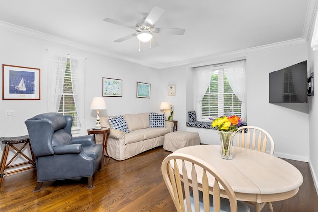 living room with crown molding, ceiling fan, a healthy amount of sunlight, and dark hardwood / wood-style floors