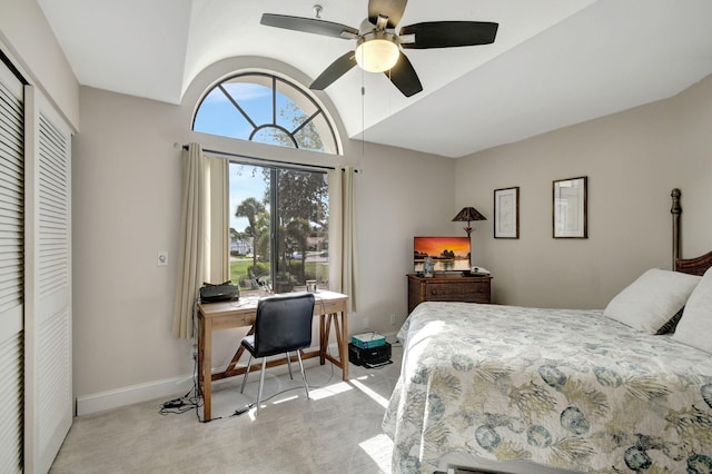 carpeted bedroom featuring ceiling fan, a closet, and vaulted ceiling