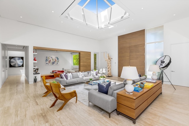 living room featuring light hardwood / wood-style flooring and a high ceiling