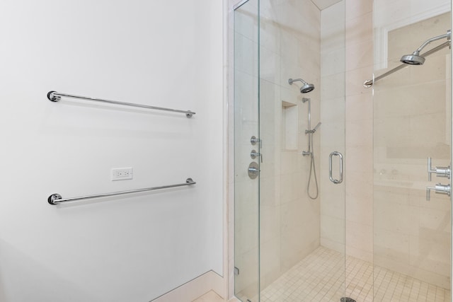 bathroom featuring a shower with shower door