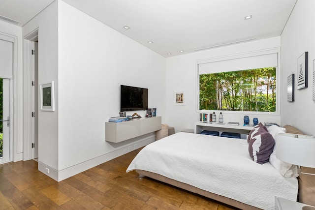 bedroom with hardwood / wood-style flooring