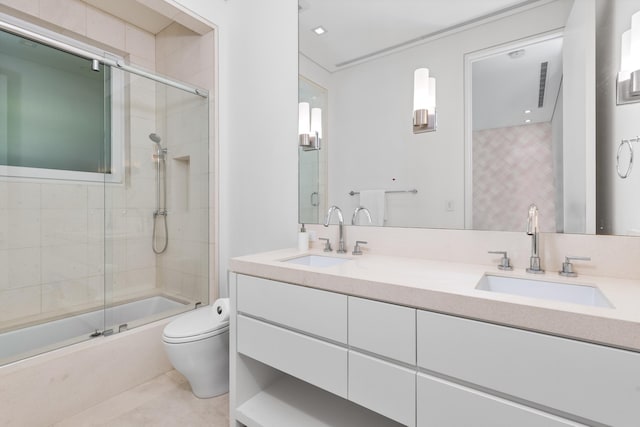 full bathroom with shower / bath combination with glass door, vanity, toilet, and tile patterned floors