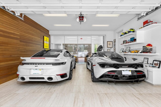 garage featuring wood walls and a garage door opener