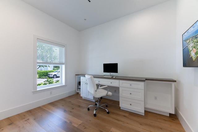 office area featuring light wood-type flooring and built in desk