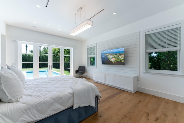 bedroom featuring light hardwood / wood-style floors, french doors, and access to exterior