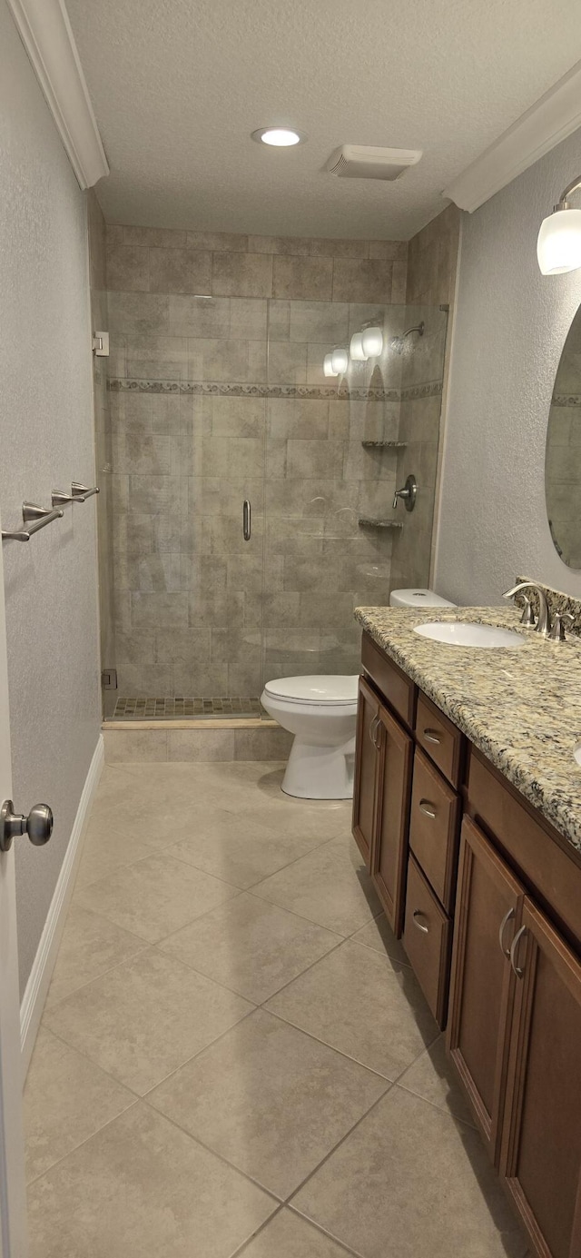 bathroom with an enclosed shower, toilet, a textured ceiling, and vanity