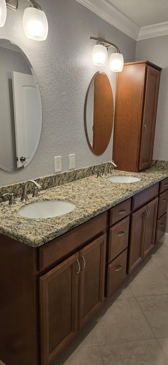 bathroom featuring tile patterned flooring, vanity, and ornamental molding