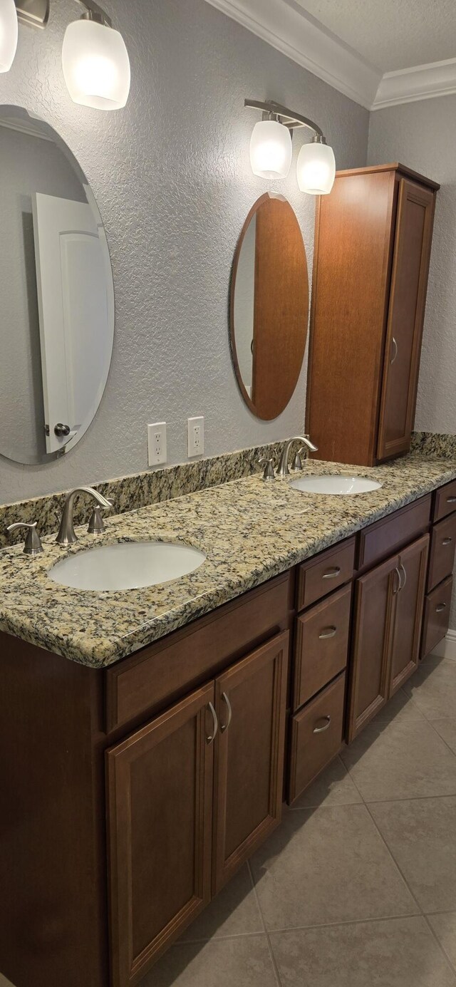 184 Burgundy D, Delray Beach, FL 33484 - bathroom with ornamental molding, double vanity, tile patterned flooring, and a textured wall