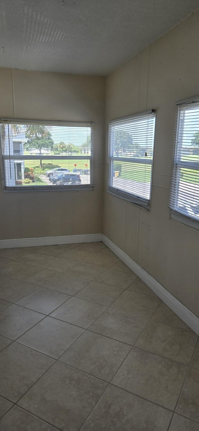184 Burgundy D, Delray Beach, FL 33484 - empty room featuring light tile patterned flooring and baseboards