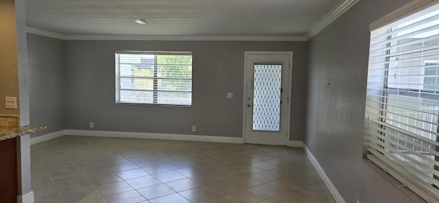 tiled empty room featuring crown molding