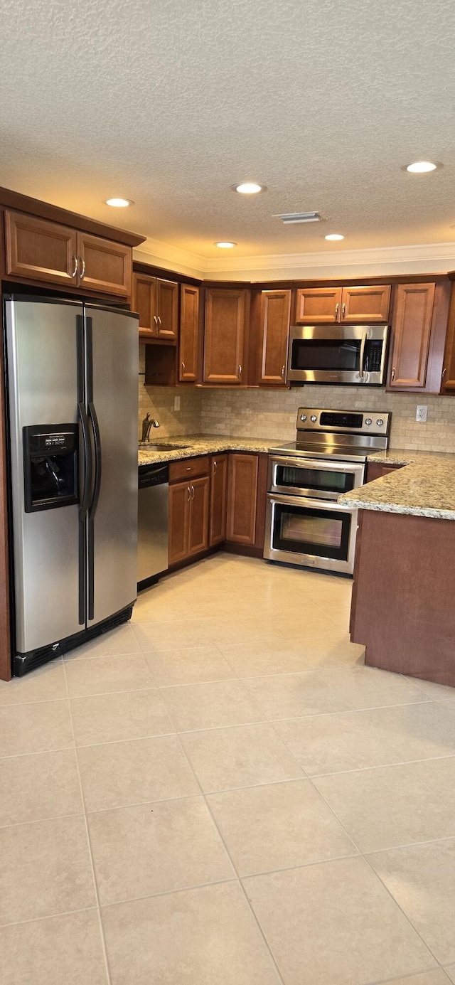 184 Burgundy D, Delray Beach, FL 33484 - kitchen with appliances with stainless steel finishes, a textured ceiling, a sink, recessed lighting, and decorative backsplash