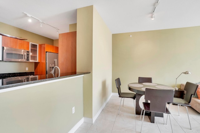 dining room with rail lighting and sink