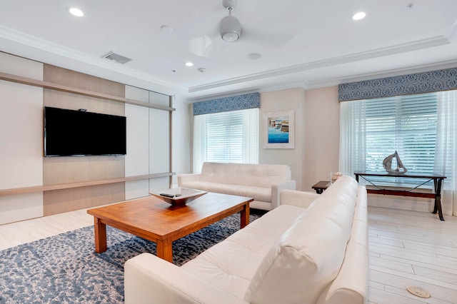 living room with crown molding, light wood-type flooring, and ceiling fan