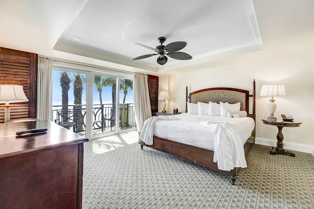 bedroom featuring access to exterior, a tray ceiling, ceiling fan, french doors, and light colored carpet