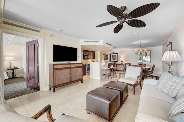 living room with light tile patterned flooring, ceiling fan with notable chandelier, and crown molding