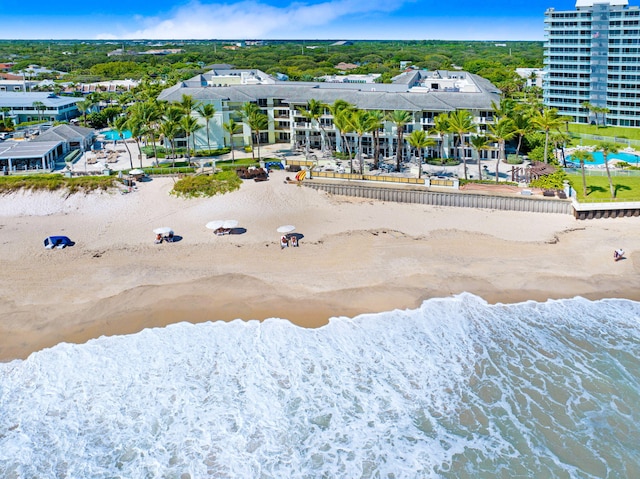 drone / aerial view featuring a beach view and a water view