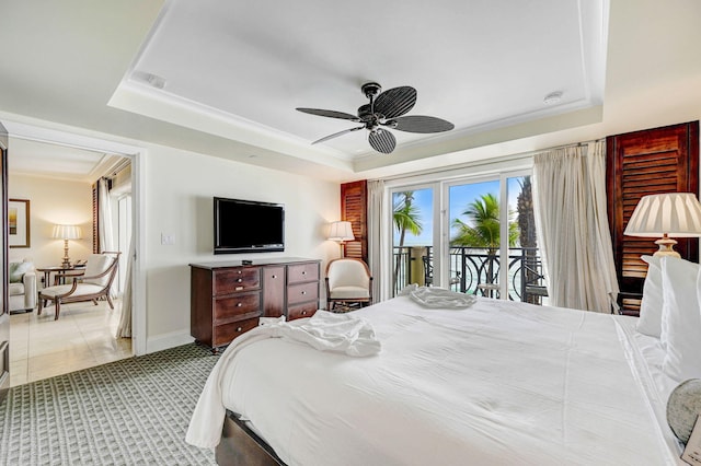 carpeted bedroom with ceiling fan, a tray ceiling, crown molding, and access to outside