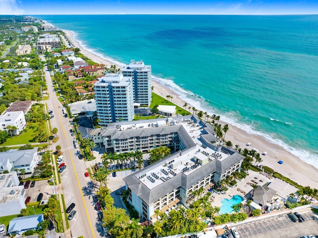 drone / aerial view featuring a beach view and a water view