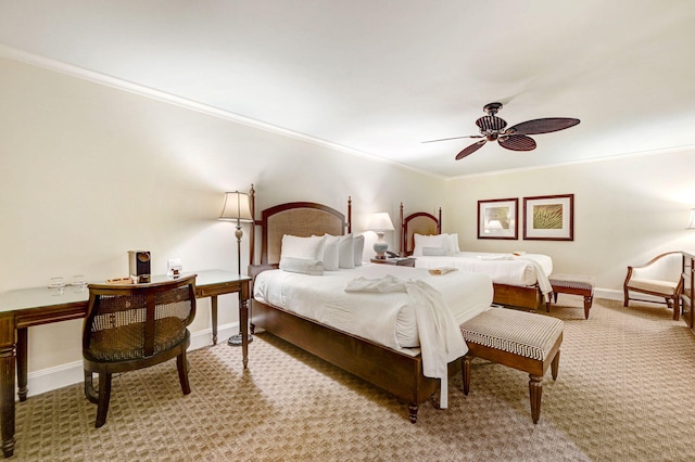 carpeted bedroom with ceiling fan and crown molding