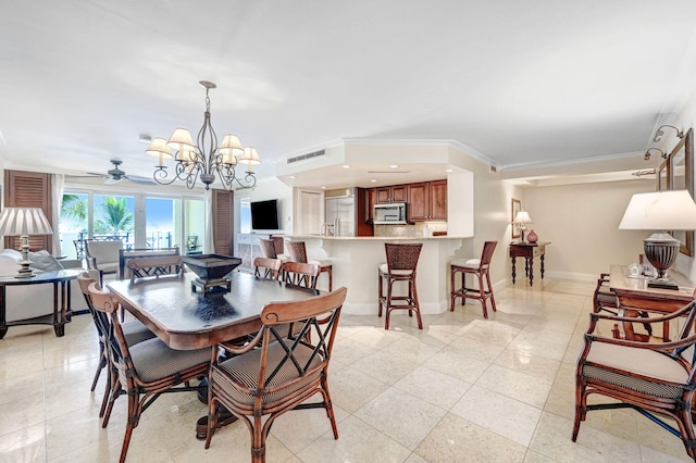 tiled dining space with ceiling fan with notable chandelier and crown molding