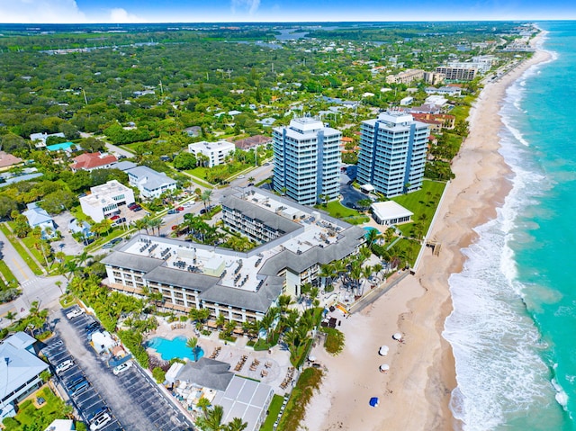 bird's eye view featuring a water view and a beach view