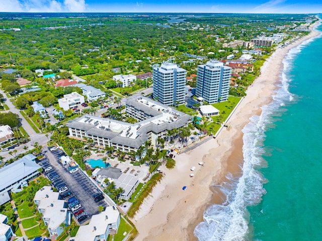 drone / aerial view with a water view and a beach view