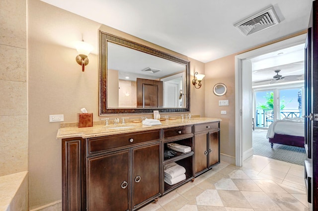 bathroom with tile patterned flooring, vanity, and ceiling fan