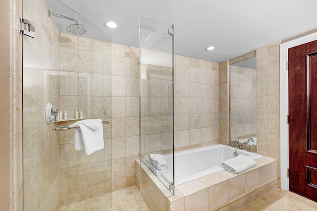 bathroom with shower with separate bathtub and tile patterned floors