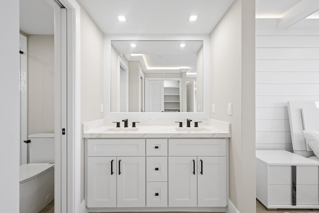 bathroom featuring vanity and toilet