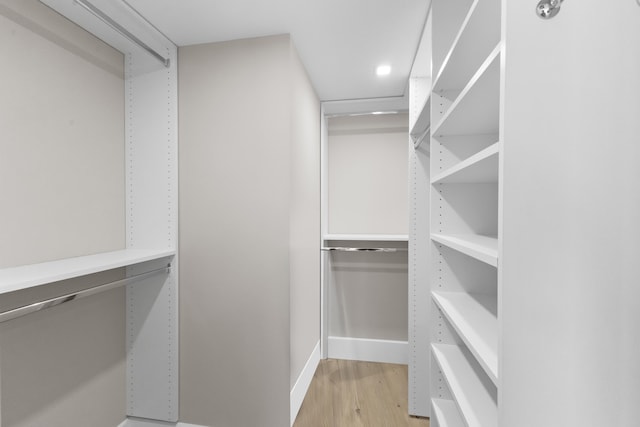 spacious closet with light hardwood / wood-style flooring