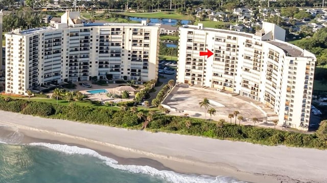 bird's eye view featuring a water view and a view of the beach