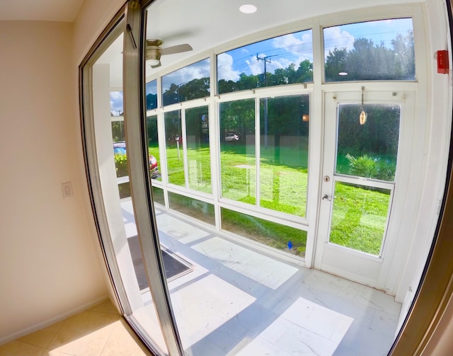 doorway to outside featuring ceiling fan