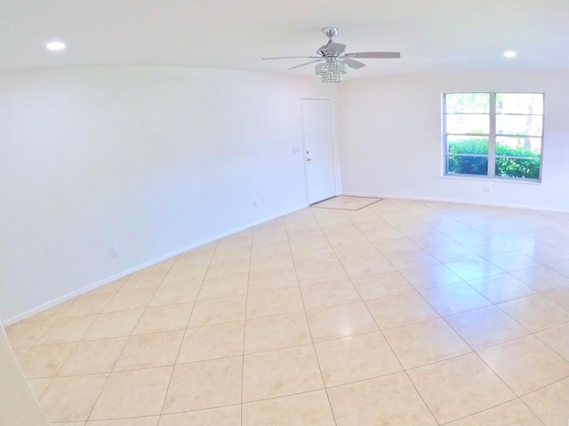 spare room featuring ceiling fan and light tile patterned flooring