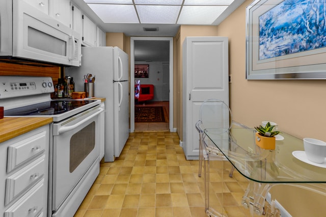 kitchen featuring white cabinetry and white appliances