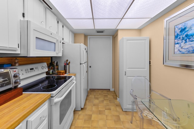 kitchen featuring white appliances and white cabinetry