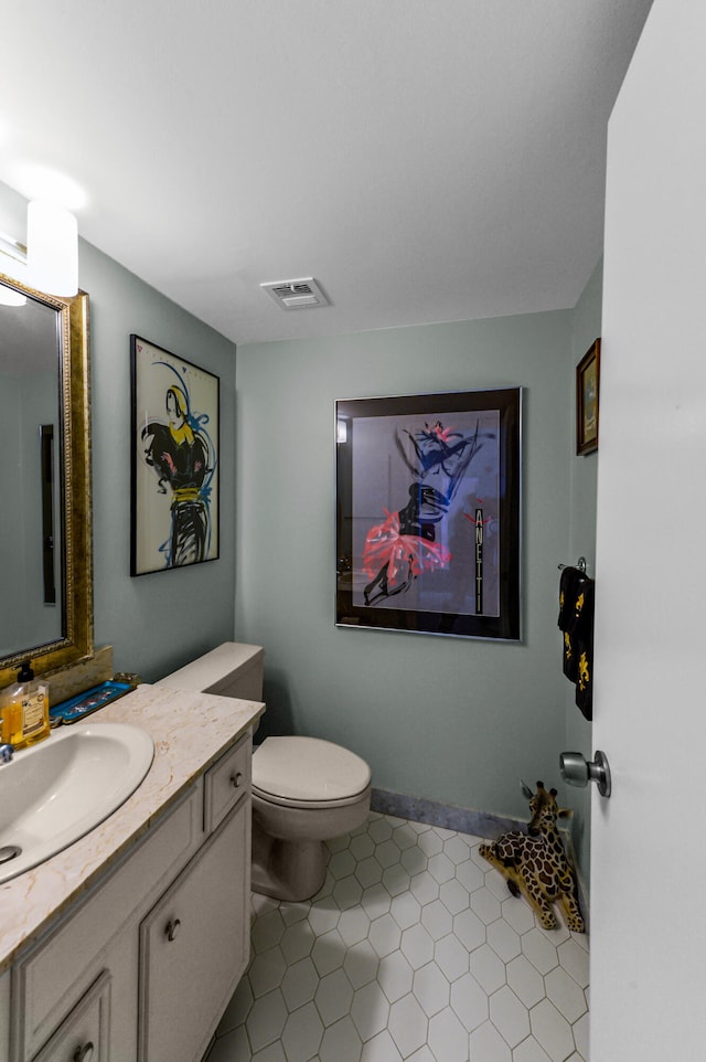 bathroom featuring vanity, toilet, and tile patterned floors