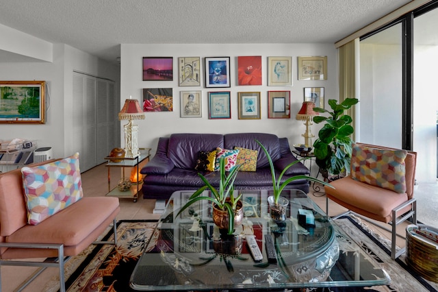 living room featuring a textured ceiling, light tile patterned floors, and a wall of windows