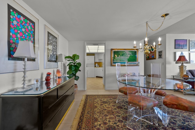 dining space featuring light tile patterned floors and an inviting chandelier